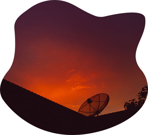 Satellite TV Graphic, image showing a satellite on a roof pointed upwards. silhouetted against a sunset